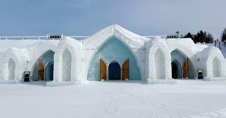 Carved chamber of ice and packed snow with a low sleeping platform under a vault