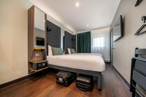 Compact standardised bedroom with a fitted bed, wall panel and narrow window